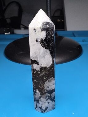 This is a polished Rainbow Moonstone obelisk point.